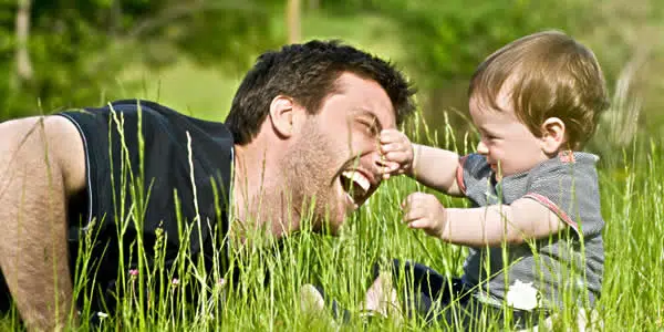 child grabbing his fathers nose