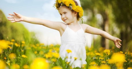 girl with flower crown in field of flowers